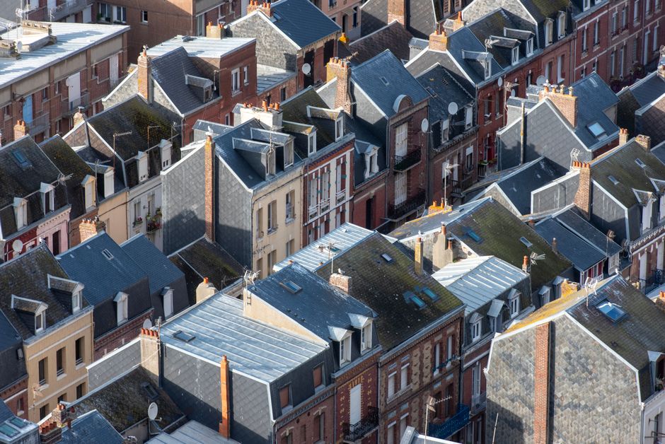Charming rooftop architecture of Le Tréport, France, viewed from above in a sunny setting.