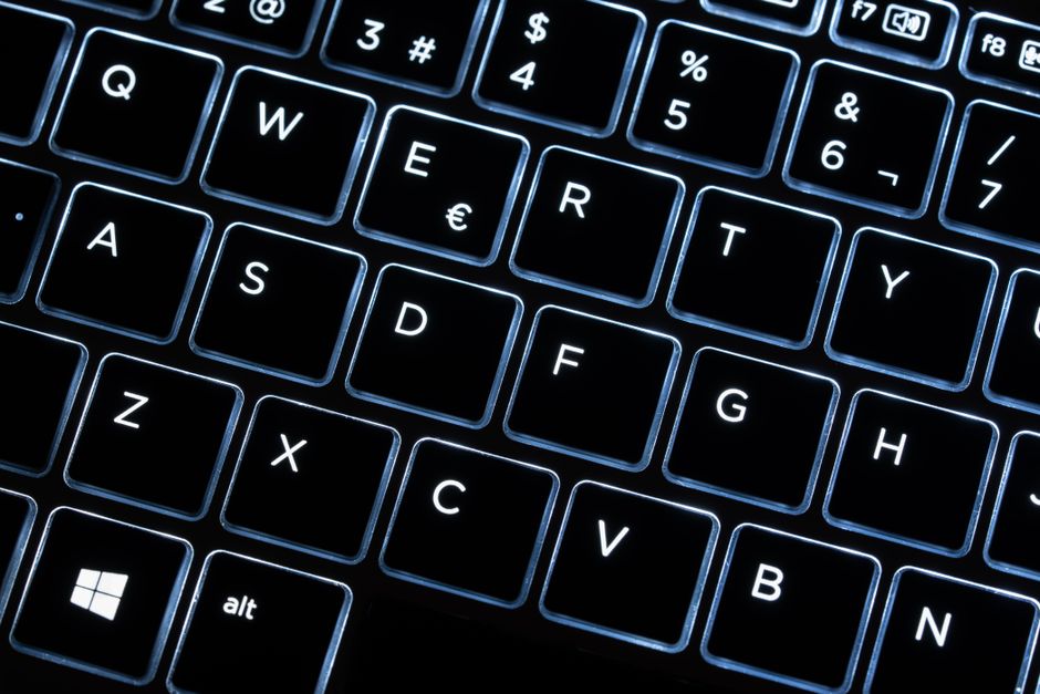 Close-up of an illuminated black keyboard showcasing modern design and technology.