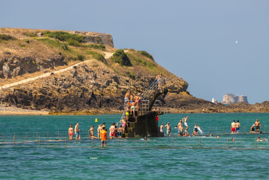 People enjoying a sunny day at the sea pool in Saint-Malo, Brittany, France.
