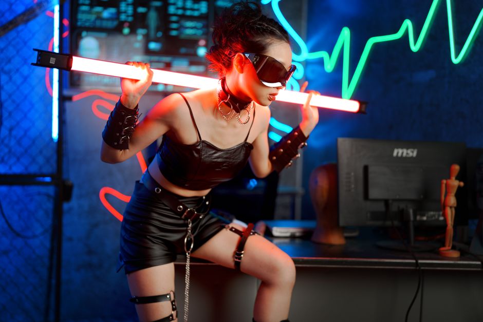 A stylish individual in leather attire with neon lights in a cyber-inspired environment.