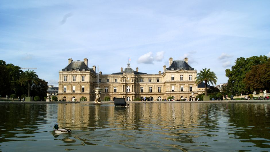 Charming view of Luxembourg Palace with pond reflections in Paris, ideal for travel inspiration.