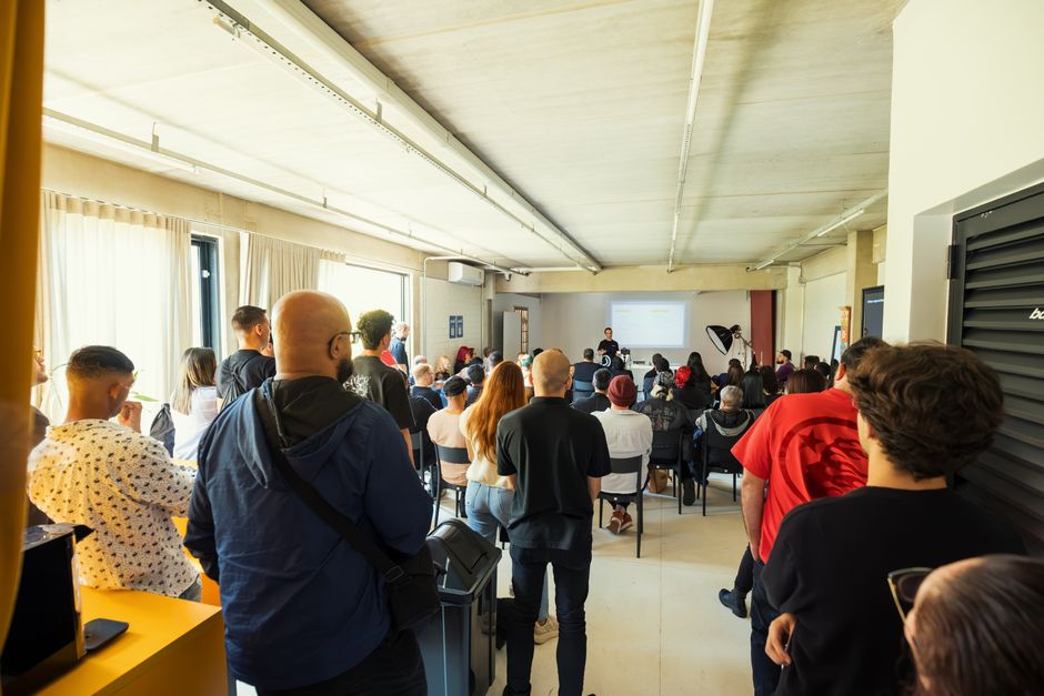 A diverse group attending a seminar in a bright, modern indoor setting.