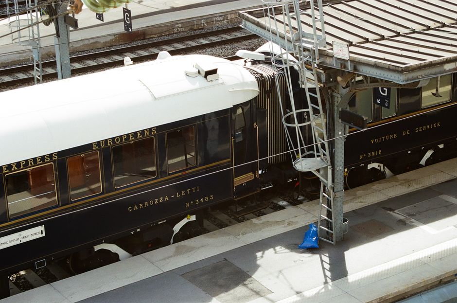 Vintage European train on a station platform, showcasing elegant railway travel.