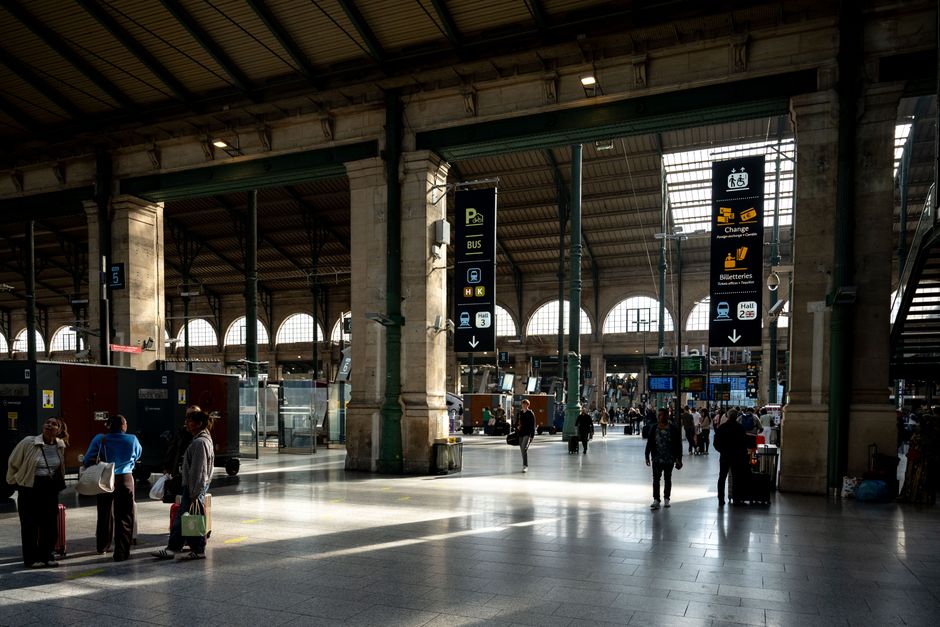 Busy interior shot of Gare du Nord showcasing travelers and iconic architecture.