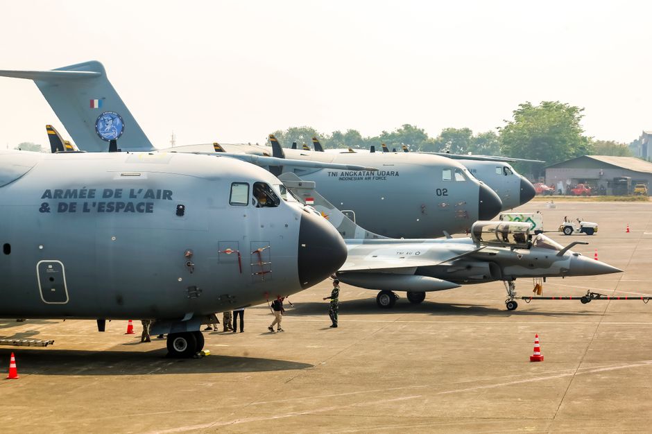 Military aircraft on display at an airbase in Jakarta, Indonesia, showcasing diverse air force capabilities.
