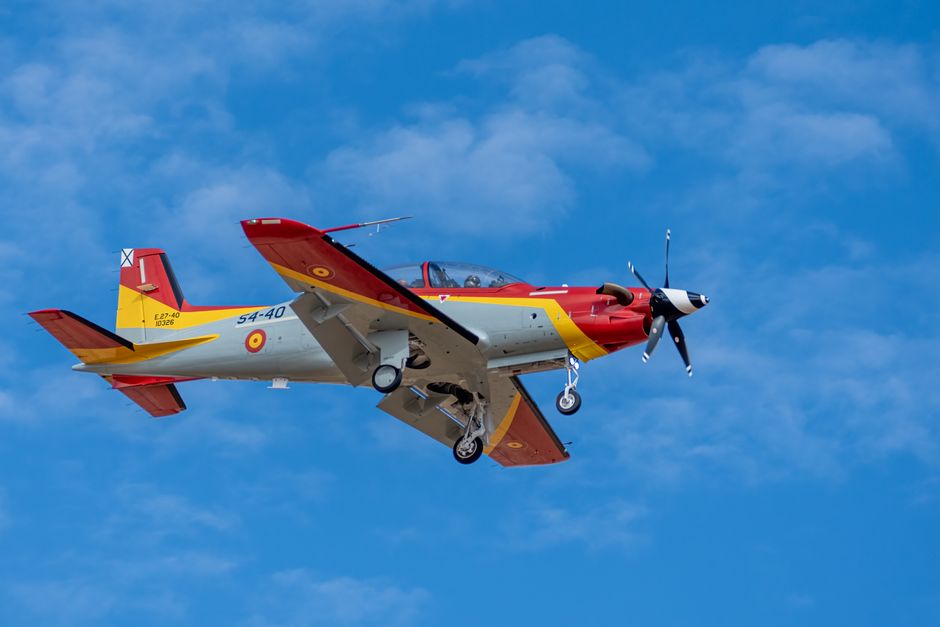 Spanish military aircraft flying over Albacete with clear blue sky background.