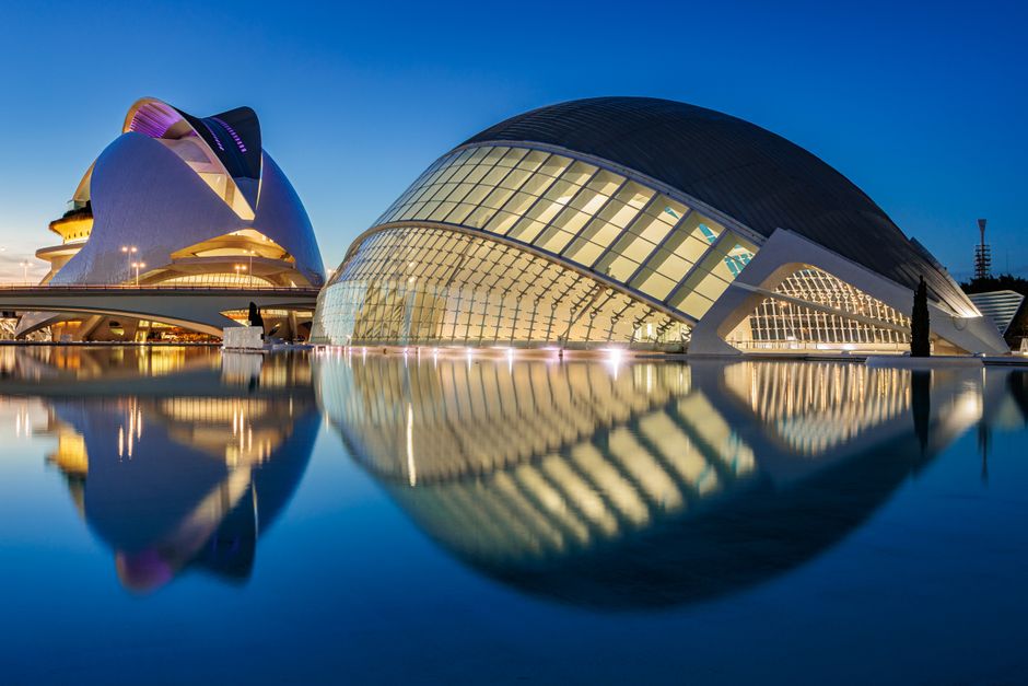The stunning architecture of Valencia's City of Arts and Sciences reflecting in water at dusk.