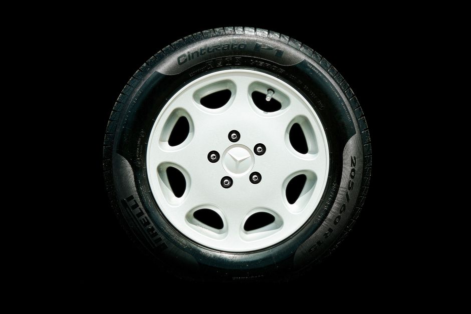 Detailed close-up of a Mercedes alloy wheel with Pirelli tire on a black background.