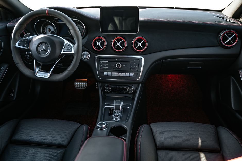 Explore the sleek and modern design of this luxury car interior featuring a detailed dashboard and steering wheel.