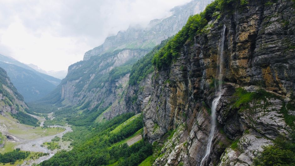 Breathtaking aerial view of the waterfall and dramatic cliffs in Sixt-Fer-à-Cheval, France.
