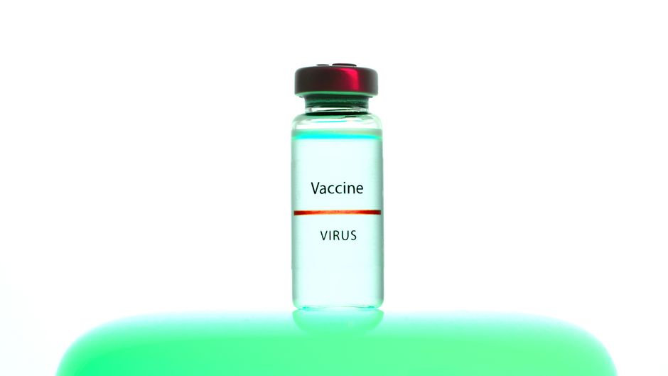 A close-up of a vaccine vial labeled 'Vaccine Virus' on a vibrant background.