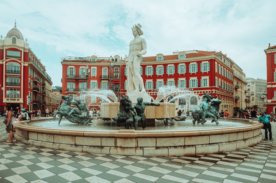 Iconic Fountain of the Sun located in Nice, France with sculptures and a vibrant square.