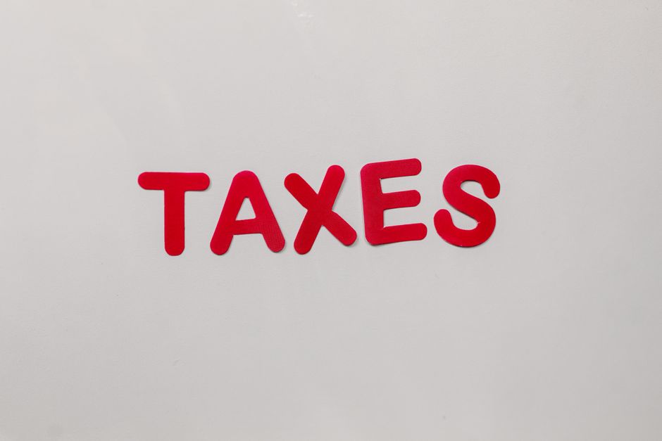 Simple and bold image of the word taxes in red letters on a white background.