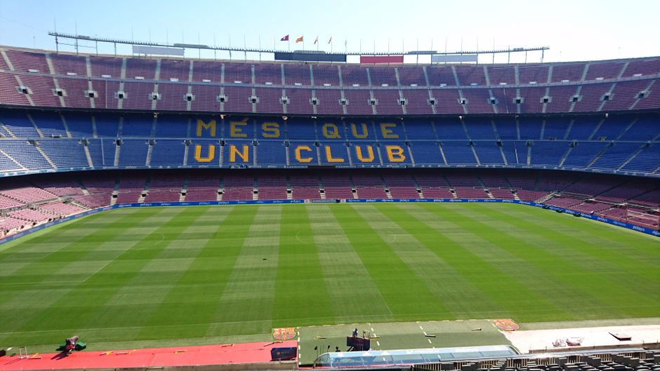 Panoramic view of Camp Nou stadium in Barcelona, home of FC Barcelona football team, with 'Mes Que Un Club' slogan.