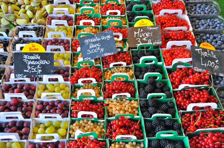 A vibrant display of assorted berries for sale at a market in Le Bois-Plage-en-Ré, France.