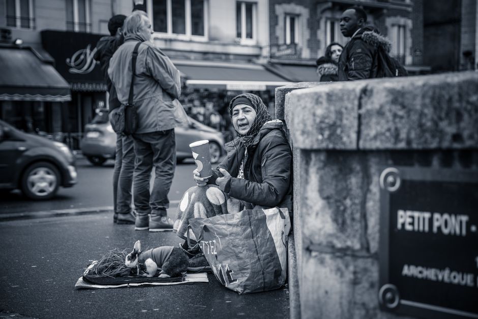 Black and white street scene at Petit Pont with a woman and passersby.