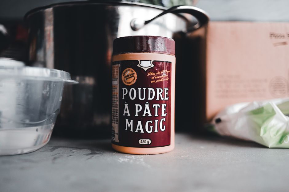 High-quality image of a baking powder container on a kitchen counter, ideal for culinary themes.